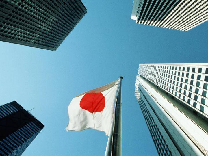 Japanese flag among city buildings